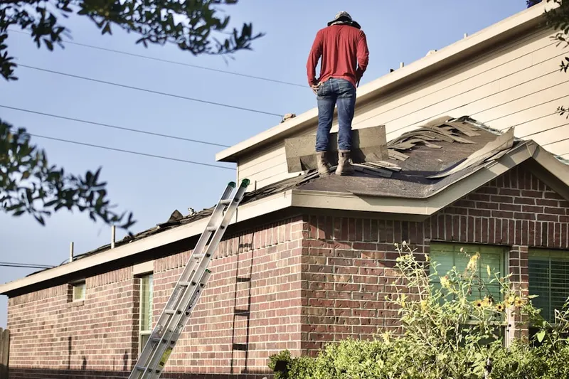 Professional roofer working on a residential roof in Creekside